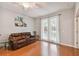 Living room with hardwood flooring and a leather sofa complemented by an art piece at 27810 Sky Lake Cir, Wesley Chapel, FL 33544