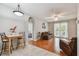 Open-concept living room with hardwood floors, bright windows, and seamless flow to the dining area at 27810 Sky Lake Cir, Wesley Chapel, FL 33544