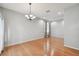 Bright living room with hardwood floors, neutral paint, and modern chandelier at 27810 Sky Lake Cir, Wesley Chapel, FL 33544