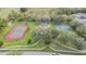 Aerial view of a neighborhood park with a tennis court, playground, and basketball court at 27810 Sky Lake Cir, Wesley Chapel, FL 33544