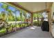 Screened-in patio featuring string lights and beautiful landscaping views at 27810 Sky Lake Cir, Wesley Chapel, FL 33544