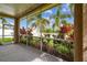 Enclosed patio with view of the backyard, landscaping, and a partial view of the pool area at 27810 Sky Lake Cir, Wesley Chapel, FL 33544
