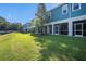 Lush backyard with a green lawn and townhome patios at 2919 Grand Kemerton Pl, Tampa, FL 33618