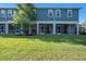 Rear view of multi-Gathering units with screened patios and manicured lawn at 2919 Grand Kemerton Pl, Tampa, FL 33618