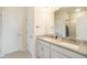 Bathroom with dual sinks, granite counters, and a glass-enclosed shower at 2919 Grand Kemerton Pl, Tampa, FL 33618