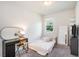 Comfortable bedroom with neutral carpet, window view, desk with oval mirror and dresser with tv at 2919 Grand Kemerton Pl, Tampa, FL 33618