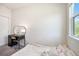 Comfortable bedroom with neutral carpet, window view and desk with oval mirror at 2919 Grand Kemerton Pl, Tampa, FL 33618