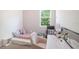 Cozy bedroom with a trundle bed, desk, accent chair, and natural light from the window at 2919 Grand Kemerton Pl, Tampa, FL 33618