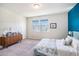 Well-lit bedroom features a blue accent wall, two windows, and a dresser at 2919 Grand Kemerton Pl, Tampa, FL 33618
