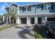 Charming townhome featuring a well-maintained front yard, paved driveway, and attached garage at 2919 Grand Kemerton Pl, Tampa, FL 33618