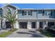 Charming townhome featuring a well-maintained front yard, paved driveway, and attached garage at 2919 Grand Kemerton Pl, Tampa, FL 33618
