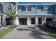 Charming townhome featuring a well-maintained front yard, paved driveway, and attached garage at 2919 Grand Kemerton Pl, Tampa, FL 33618