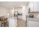 Bright kitchen with white cabinets, stainless steel appliances, and a granite countertop island with seating at 2919 Grand Kemerton Pl, Tampa, FL 33618