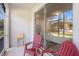 Covered lanai with red chairs, offering a relaxing outdoor space at 2919 Grand Kemerton Pl, Tampa, FL 33618