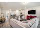 Open-concept living space with tile floors, white walls, and a kitchen with stainless appliances at 2919 Grand Kemerton Pl, Tampa, FL 33618