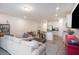 Open-concept living space with tile floors, white walls, and a kitchen with stainless appliances at 2919 Grand Kemerton Pl, Tampa, FL 33618