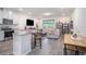 Open floor plan combining the kitchen and living room with hardwood style floors and bright natural light at 2919 Grand Kemerton Pl, Tampa, FL 33618