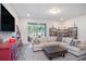 Comfortable living room featuring a neutral color palette, large windows, and shelving at 2919 Grand Kemerton Pl, Tampa, FL 33618