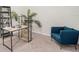 Office features neutral carpet, a modern wood desk, a shelf, a plant and a blue chair at 2919 Grand Kemerton Pl, Tampa, FL 33618