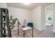 Office features neutral carpet, a modern wood desk, a shelf, a plant and a blue chair at 2919 Grand Kemerton Pl, Tampa, FL 33618