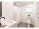 Simple bathroom featuring shower with white tile, a white sink and toilet at 3316 Port Charlotte Blvd, Port Charlotte, FL 33952