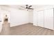 Empty bedroom featuring wood floors, a ceiling fan, and large closets at 3316 Port Charlotte Blvd, Port Charlotte, FL 33952