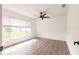 Empty bedroom featuring wood floors, a ceiling fan, and large windows at 3316 Port Charlotte Blvd, Port Charlotte, FL 33952