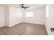Empty bedroom featuring wood floors, a ceiling fan, and large windows at 3316 Port Charlotte Blvd, Port Charlotte, FL 33952