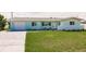 Charming single-story home featuring a well-manicured lawn and an attached one car garage at 3316 Port Charlotte Blvd, Port Charlotte, FL 33952