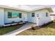 Charming single-story home featuring a well-manicured lawn and a neatly landscaped walkway at 3316 Port Charlotte Blvd, Port Charlotte, FL 33952