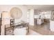 Stylish workstation featuring a glass desk and chair, with a view into the kitchen and dining area at 3316 Port Charlotte Blvd, Port Charlotte, FL 33952