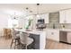 Bright kitchen boasts white cabinets, stainless steel appliances, and a stylish island with bar seating at 3316 Port Charlotte Blvd, Port Charlotte, FL 33952