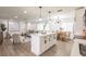 Open concept living space featuring a kitchen island, dining area, and living room with modern decor at 3316 Port Charlotte Blvd, Port Charlotte, FL 33952