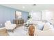 A modern living room featuring stylish furnishings, hardwood floors, and bright, neutral walls at 3316 Port Charlotte Blvd, Port Charlotte, FL 33952