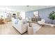 A modern living room featuring an open floor plan, stylish furnishings, and hardwood floors at 3316 Port Charlotte Blvd, Port Charlotte, FL 33952