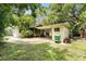 Lush backyard with mature trees, carport, and an inviting patio area perfect for outdoor enjoyment at 3709 W San Pedro St, Tampa, FL 33629