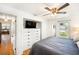 Comfortable bedroom with ceiling fan, mounted TV and closet storage at 3709 W San Pedro St, Tampa, FL 33629