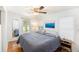 Bedroom with a full size bed, ceiling fan, and views from two large windows at 3709 W San Pedro St, Tampa, FL 33629