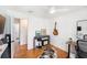 Cozy bedroom featuring wood floors, ceiling fan, and an acoustic guitar at 3709 W San Pedro St, Tampa, FL 33629