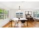 Bright dining area featuring hardwood floors and modern decor with views of the backyard at 3709 W San Pedro St, Tampa, FL 33629