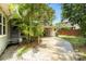 Extended driveway leading to a carport, surrounded by mature landscaping and greenery for added privacy at 3709 W San Pedro St, Tampa, FL 33629