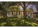 Charming single-story home with a lush front lawn and mature trees in the evening light at 3709 W San Pedro St, Tampa, FL 33629