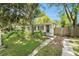 Single-story home with mature landscaping, stone walkway, and driveway with a privacy fence at 3709 W San Pedro St, Tampa, FL 33629