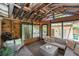Cozy sunroom with exposed beams, wood accents, and comfortable seating creates a relaxing space at 3709 W San Pedro St, Tampa, FL 33629