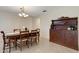 Dining room with chandelier lighting features a vintage hutch and wooden table with 6 chairs at 4160 Fruitville Rd # 77, Sarasota, FL 34232