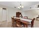 Dining room with chandelier lighting and tile flooring features a vintage hutch and wooden table with 6 chairs at 4160 Fruitville Rd # 77, Sarasota, FL 34232