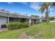 View of light gray condos from the back with a common yard space at 4160 Fruitville Rd # 77, Sarasota, FL 34232