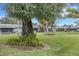 Condo complex with shared green lawn and beautiful mature trees at 4160 Fruitville Rd # 77, Sarasota, FL 34232