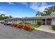 Exterior shot of condominiums with tidy landscaping and nearby parking at 4160 Fruitville Rd # 77, Sarasota, FL 34232