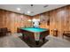 Spacious game room featuring a pool table with green felt, wood paneling, and laminate floors at 4160 Fruitville Rd # 77, Sarasota, FL 34232